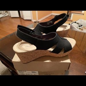 Brand new never worn Clark’s Sandals 61/2 wide black wedges super cute